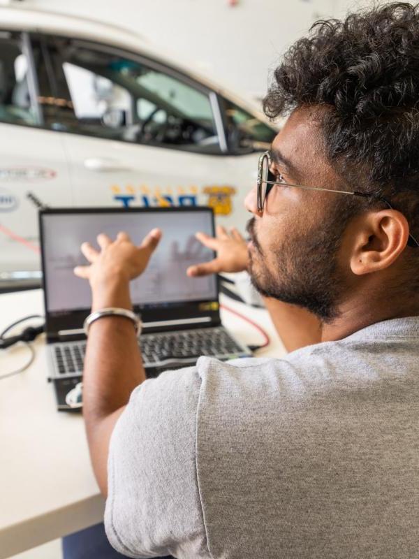 A graduate student works on a vehicle project in the MRC.